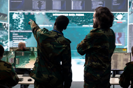 Infantry unit staff talking about enemy vessel gps location in control center, analyzing real time information for national safety mission in command post. Army personnel gathering intelligence.の写真素材