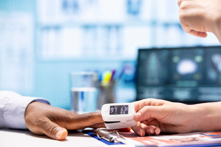 Skilled doctor taking the oxygen saturation measurement to check vital signs and parameters,...