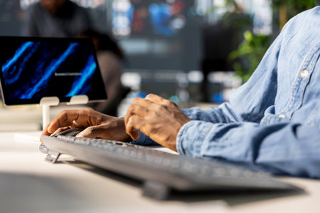 Black business manager engaged in budget analysis and strategy development at workstation, supporting objectives for company growth and employee collaboration. Strategizing business goals. Close up.の写真素材