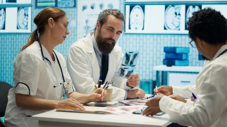 Healthcare experts in a meeting discussing treatment protocols and improvements. Doctors and nurses evaluating diagnostic results in a private clinic to enhance medical services quality. Camera A.の写真素材