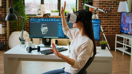 Asian woman engineer creating prototypes with vr glasses and 3D modeling software, working from home...