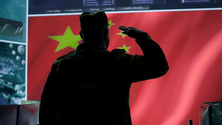Military analyst from China reviews surveillance data in an army monitoring room headquarters. Chinese soldiers presenting the national flag. Camera A.の写真素材