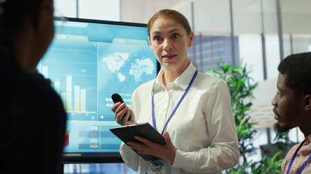 Group of business associates discussing project development plans, leveraging big data and advanced analytics to make informed decisions and enhance workflow. Camera A.の写真素材