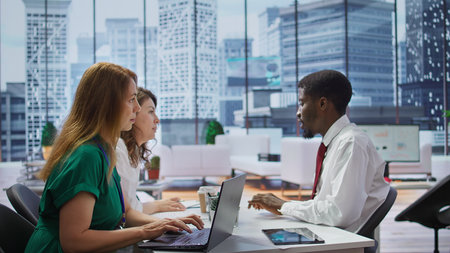 Human resources staff interviewing a male job candidate in office, reviewing his resume and discussing qualifications. Ensuring potential for career advancement within the company. Camera B.の写真素材