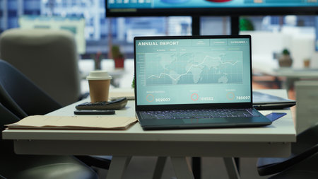 High end business office with a computer displaying detailed analytics, perfect for executive company meetings or financial planning and project development in a multinational corporation.の写真素材