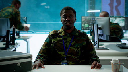 Army personnel in a high tech command center attends a videocall meeting and communicating crucial information from surveillance systems and cctv. Support national security operations. Camera A.の写真素材