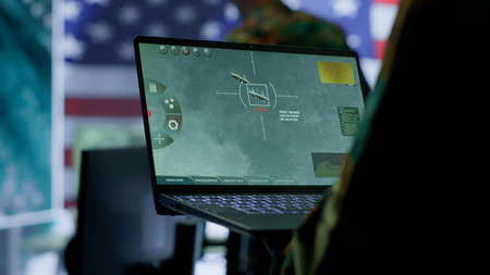 Intelligence officers in american military uniforms work on computers in a command post, managing...