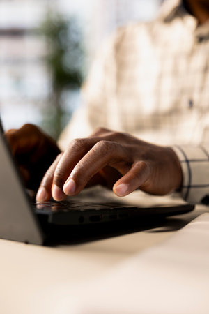 Successful entrepreneur working on financial forecasts at his desk, using data and technology to...