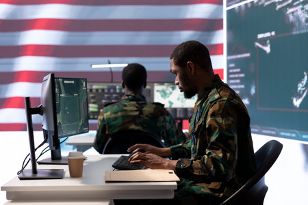 Team of military personnel manages surveillance and security operations from a high tech command...