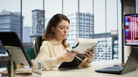 Corporate leader signing work contracts and agreements to approve leave requests and other documents for productivity. CEO businesswoman working on legal management, success story. Camera B.の写真素材