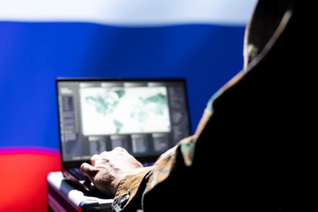 Russian soviet army expert analyzes aerial reconnaissance data to come up with tactics gaining battlefield advantage. Kremlin regime agent in command room controls drones attacking strategic targetsの写真素材