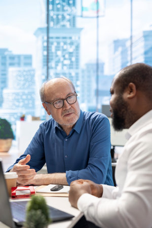 Mature couple receiving expert financial advice on retirement planning, focusing on maximizing savings and long term financial security. Counseling on life insurance and funds from planner.の写真素材