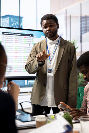 Financial manager presenting his market expansion ideas in a meeting with the advisory board, working to increase business profit. Team members evaluating market trends to create a strategy.の写真素材
