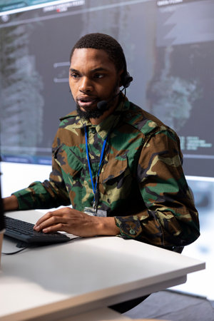 Government intelligence officer handling surveillance operations from cctv satellite system,...
