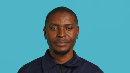 Portrait of security agent celebrating achievements after securing assigned post, studio background....