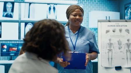 Expert physician discuss healthcare records with colleagues in a meeting, clinic staff coordinating effective treatment strategy. Doctors at a private facility analyzing test results. Camera A.の写真素材