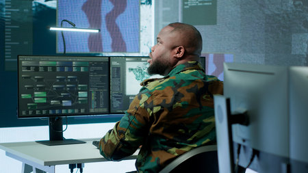 High tech military office with soldiers analyzing real time data, processing intelligence information and coordinating strategic operations to support army field missions effectively. Camera A.の写真素材