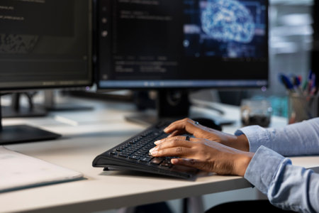 Engineer typing on keyboard in server hub, monitoring data center energy consumption using AI...