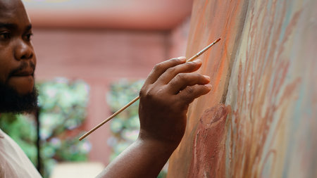 Painter uses a variety of brushes and paint tubes to create masterpiece for the fine art gallery exhibition, creative atelier. Working on colorful artwork with creativity and dedication. Camera A.の写真素材