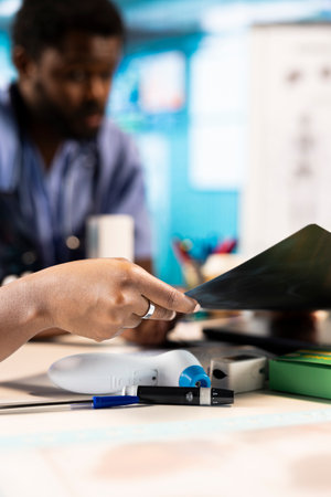 Team of trainee nurses analyzing patient health records during a meeting, utilizing x ray and mri scans with expert physician for a training session. Assistants work with medic.の写真素材