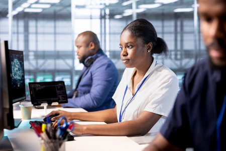 Data center engineers using programming languages to construct algorithms and build applications. Server hub workers designing and deploying software architectures, debugging and optimizing codeの写真素材
