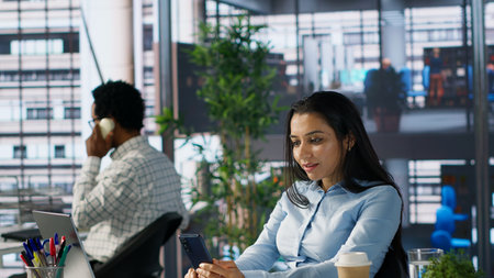 Indian company executive participates in a remote meeting, reviewing performance metrics and...