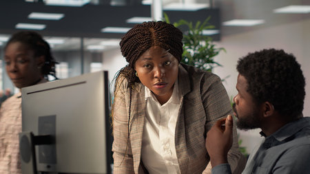 Business staff working together to review financial forecasts and analytics, doing a brainstorming session with archived documents for project development. Achieving goals for growth. Camera A.の写真素材