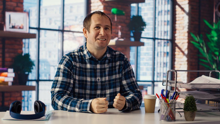 Manager in home office sitting at desk, filming onboarding video for job candidates. Supervisor doing human relations job, recording video answering inquiries from employees, camera Bの写真素材