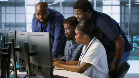 Coworkers in data center doing brainstorming, implementing AI predictive maintenance systems. Server hub colleagues discussing, using artificial intelligence to identify hardware failures, camera Aの写真素材