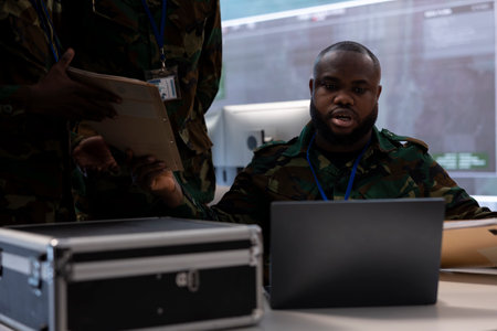 Government army experts in advanced command post overseeing surveillance activity, coordinate security protocols and collect real time data for field military missions. Control tower.の写真素材