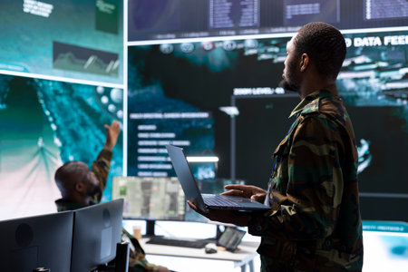 Military staff in high tech command post work on data integration, processing real time surveillance...