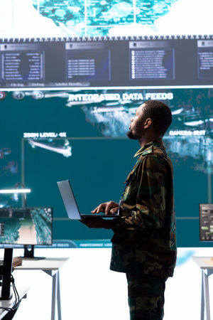 Military personnel operating in a secure office environment, processing critical information and...