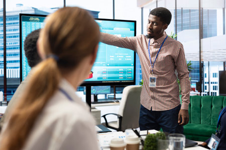 Diverse work team discussing digital marketing trends on interactive board, using analytics to...