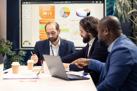 Startup employees exchanging project details and essential information about achieving business...
