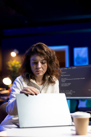 IT expert working from home, opening laptop, testing and deploying programs and systems. Engineer...