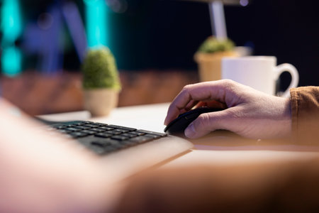 Teleworking computer technician typing on keyboard, implementing security measures to protect...