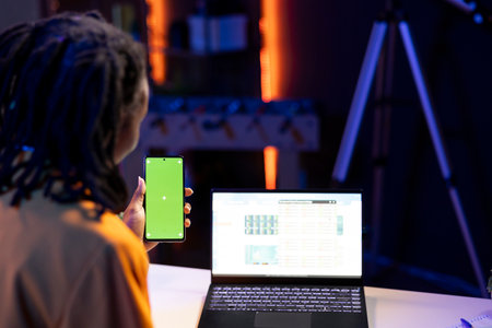 Freelancing broker investor holding green screen mockup phone, checking stock exchange valuation...