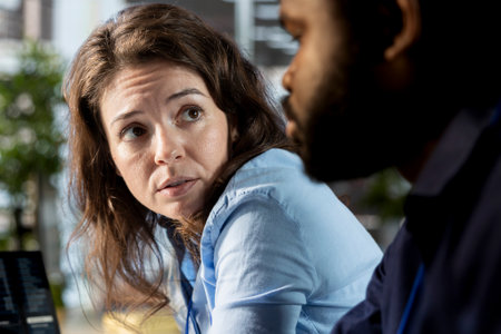 Multiethnic staff members examines monthly revenue balance at workstation, planning next steps in...