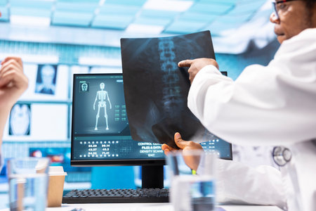 Medical expert specialist explaining the x ray imaging for a diagnosis, doing scan interpretation during check up consultation. Professional medic gives feedback to female client.の写真素材