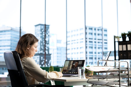 Successful female entrepreneur collaborates with her experts team, focusing on problem solving, decision making and achieving strategic business objectives. Determination and authority.の写真素材