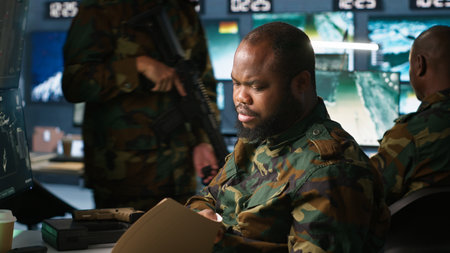 Counterintelligence specialist in military HQ base gathering information on enemy troops. African...