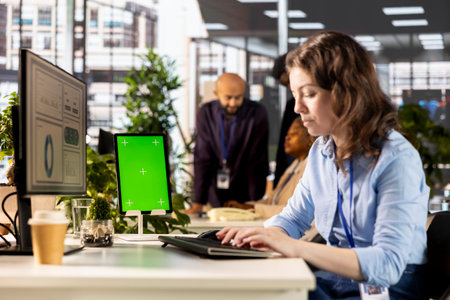 Office worker analyzing online statistics next to copy space mockup, working on resource allocation...