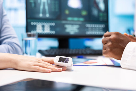 Physician using an oximeter on patient to measure oxygen levels and saturation, checking vital signs...