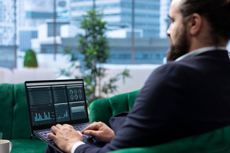 Visionary entrepreneur sits in a high end corporate workspace, focusing on investment planning and...