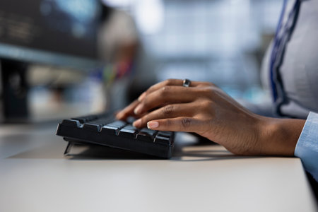Engineer typing on keyboard, optimizing infrastructure for maximum efficiency and uptime. Close up of IT expert maintaining optimal system performance, performing backupsの写真素材