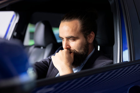 Client doing thorough car test drive, making sure he feels comfortable and enjoys driving vehicle. Customer trying out new automobile before purchase, to see if it is right for his needsの写真素材