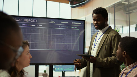 Coworkers engaging in a problem solving meeting at a corporation, using an interactive board to visualize data and develop solutions for complex challenges. Analysis presentation. Camera B.の写真素材