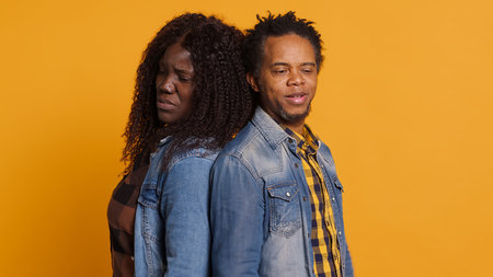 Furious offended couple having an argument and screaming at each other, dealing with marriage difficulties and misunderstandings. Annoyed frustrated man and woman quarreling. Camera A.の写真素材