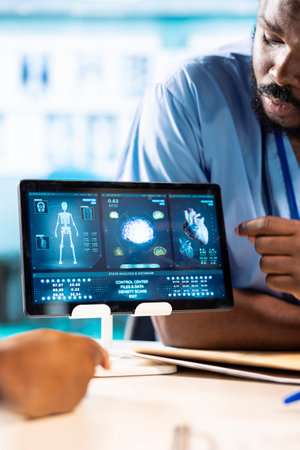 African American doctor discussing with her nurses residents to find treatment options, showcasing teamwork and professionalism in the healthcare industry. Improving the services at clinic.の写真素材