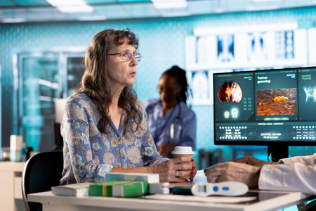 Male specialist examining a female patient in cabinet discussing about treatment plan for recovery,...